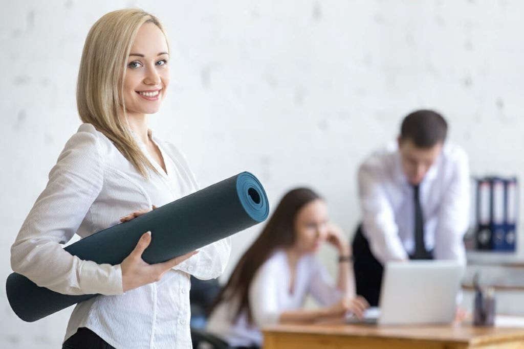 Concept of a cost-effective employee wellness program with staff participating in fitness, mindfulness, and wellness initiatives at work