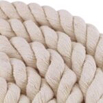 coiled Faxco 10ft natural cotton rope on wooden table, showcasing triple-strand texture and earthy beige color for a rustic unboxing vibe