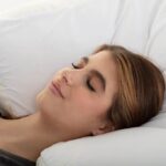 Woman sleeping peacefully on LOFE organic buckwheat pillow with perfect neck alignment