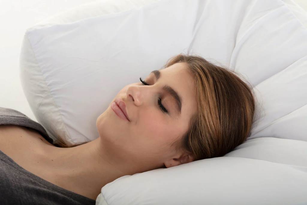 Woman sleeping peacefully on LOFE organic buckwheat pillow with perfect neck alignment