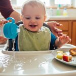 Toddler drinking from weighted straw system cup at kitchen table