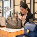 Atlanta boutique owner inspecting authentic luxury handbag during trade-in