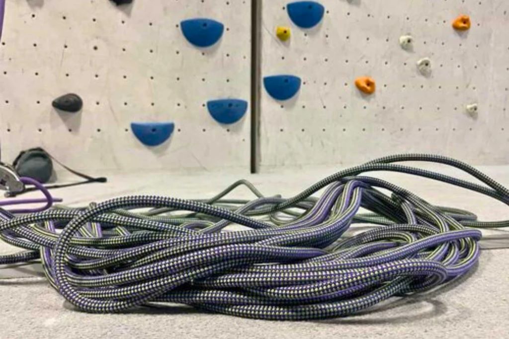 Child climbing a rope in a safe backyard play set