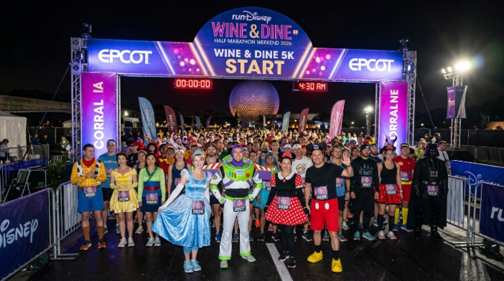 Runners in Disney costumes at the starting corral of the Disney Wine and Dine 5K at 4:30 a.m. during the 2026 runDisney Wine and Dine Half Marathon Weekend
