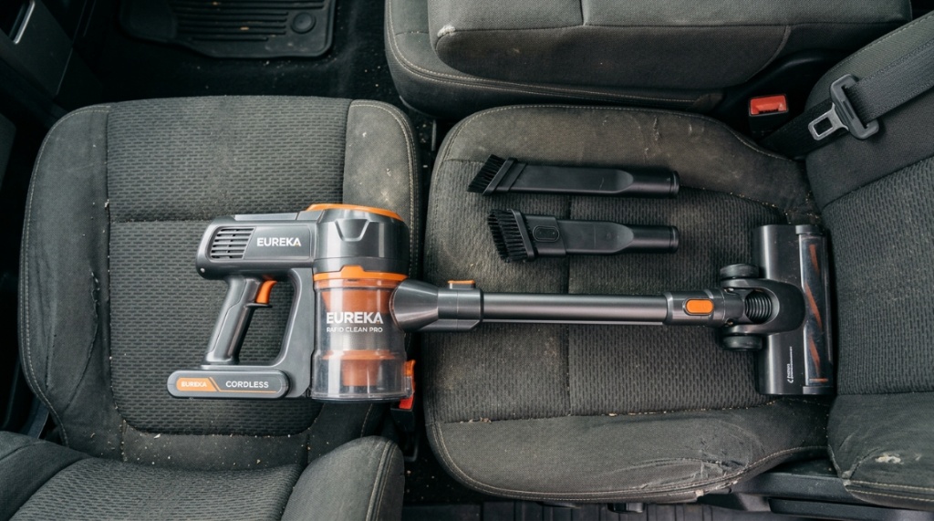 Cordless vacuum cleaner attachments displayed on a truck seat.
